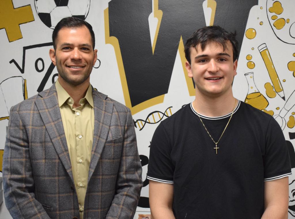 two people standing in front of colored wall